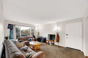 Carpeted living room with baseboards