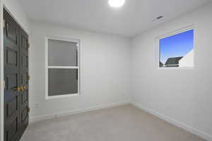 Unfurnished bedroom with carpet flooring and baseboards