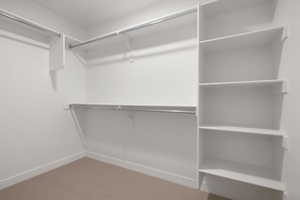 Spacious closet with light colored carpet