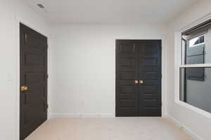 Carpeted entrance foyer with baseboards