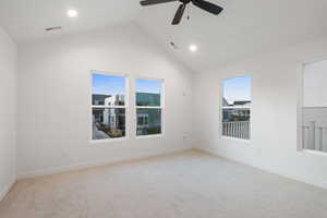 Spare room featuring light carpet, ceiling fan, high vaulted ceiling, and recessed lighting