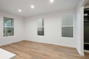 Unfurnished room with light wood-style floors and recessed lighting
