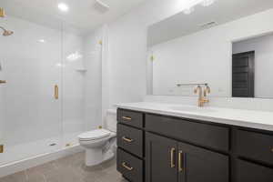 Full bathroom with vanity, a stall shower, light tile patterned floors, and recessed lighting