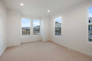 Unfurnished room featuring light carpet and recessed lighting