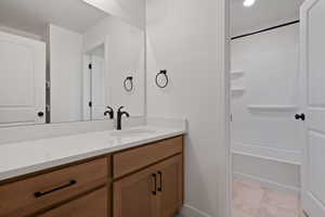 Full bathroom with vanity, light tile patterned flooring, and shower / tub combination