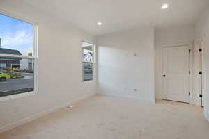 Unfurnished room featuring light carpet and recessed lighting