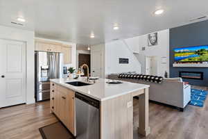 Kitchen featuring natural wood cabinetry and stainless steel appliances