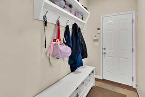 Mudroom featuring wood finished floors and baseboards