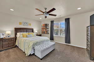 Carpeted bedroom with a ceiling fan and recessed lighting