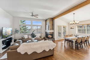 Living area featuring a tiled fireplace, hardwood / wood-style floors, ceiling fan, and recessed lighting