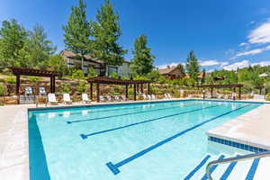 Community pool with a pergola and a patio