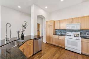 Kitchen featuring beautiful granite surface and large span low bar