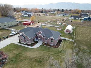 Aerial view of property and surrounding area featuring a mountainous background