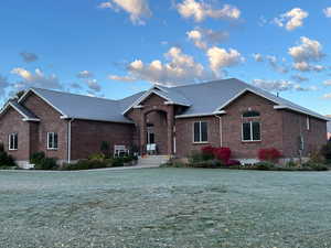 View of front facade with brick siding and a front yard