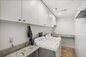 Main-floor laundry room with counter space and storage