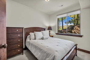 Bedroom with carpet floors and baseboards