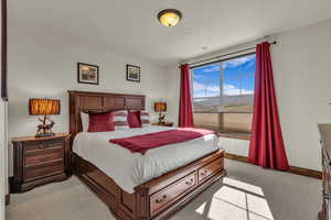 Bedroom featuring light carpet