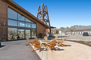 View of patio / terrace with a fire pit and a residential view