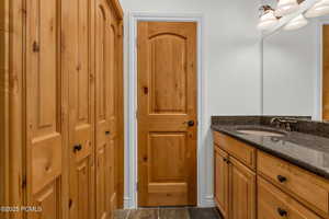 Bathroom with vanity and a closet