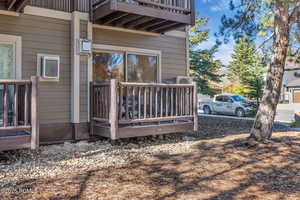 View of side of home with a balcony and a wooden deck