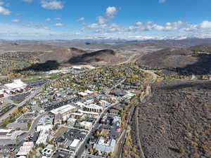 Aerial view of property and surrounding area with a mountain backdrop