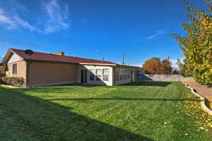 Back of property with a chimney and brick siding