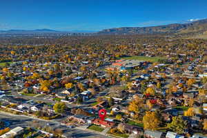 Aerial view of property's location featuring a mountain backdrop and nearby suburban area
