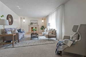 Living room with a textured ceiling and carpet floors
