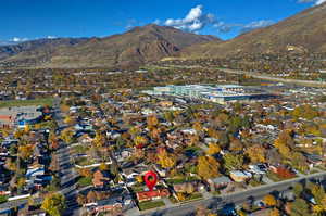 Aerial view of property and surrounding area featuring mountains