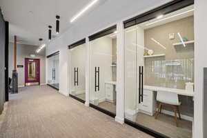 Hall featuring light wood-style floors and a desk