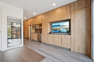 Unfurnished living room featuring light wood-style flooring and recessed lighting