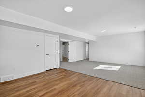 Empty room with light wood-type flooring and recessed lighting