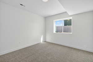 Spare room with baseboards and carpet