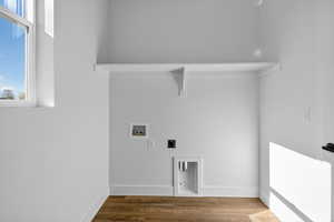 Laundry room featuring wood finished floors, washer hookup, and hookup for an electric dryer