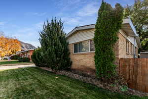 View of side of home with a mountain view and brick siding