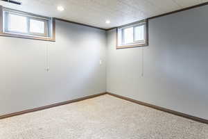Basement featuring baseboards and crown molding
