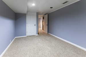 Unfurnished bedroom with light carpet and recessed lighting