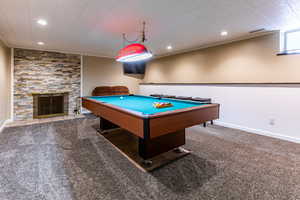 Game room with billiards table, carpet flooring, recessed lighting, crown molding, and a fireplace