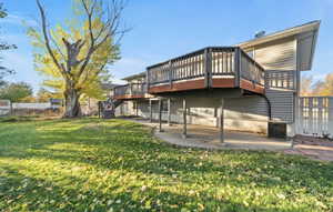 Rear view of property with a wooden deck, a patio, and stairway