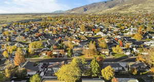 Aerial overview of property's location with a mountainous background and nearby suburban area