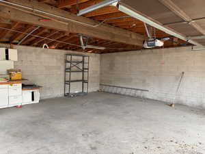 Garage with concrete block wall and a garage door opener