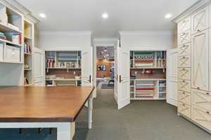 Home office with ornamental molding, dark colored carpet, and recessed lighting