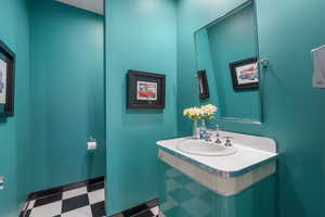 Half bath featuring vanity and tile patterned floors