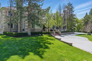 View of property's community with a yard and a patio area