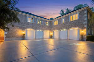 View of front of property with brick siding, driveway, and an attached garage