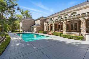 View of swimming pool with ceiling fan and a patio