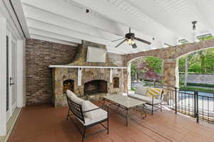 View of patio / terrace featuring an outdoor living space with a fireplace and a ceiling fan