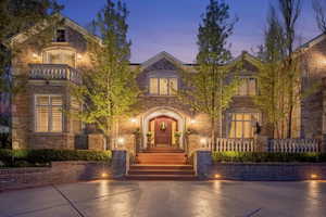 View of front facade featuring brick siding and a balcony
