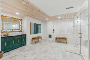 Living area featuring wooden ceiling and recessed lighting