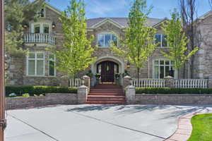View of front of property featuring brick siding and a balcony